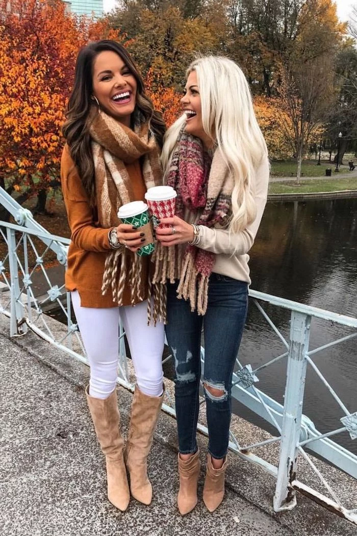 two women standing on a bridge outfit ideas for women wearing jeans and white leggings blouses large scarfs brown velvet boots