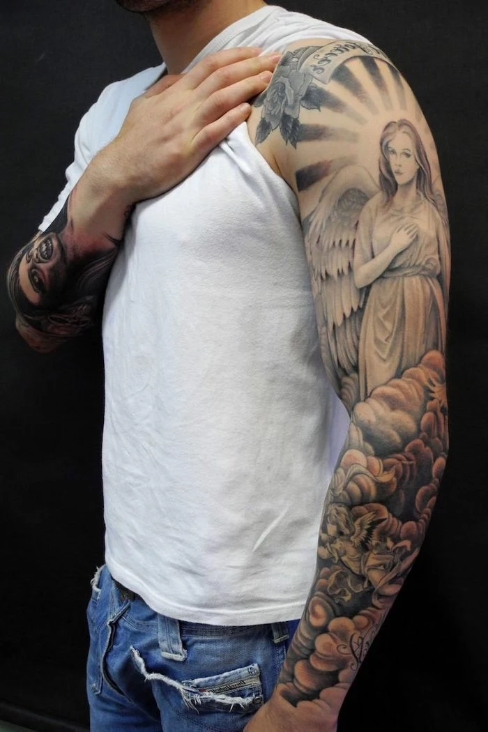 arm sleeve tattoo of female angel above clouds strength symbol tattoo man wearing white t shirt jeans