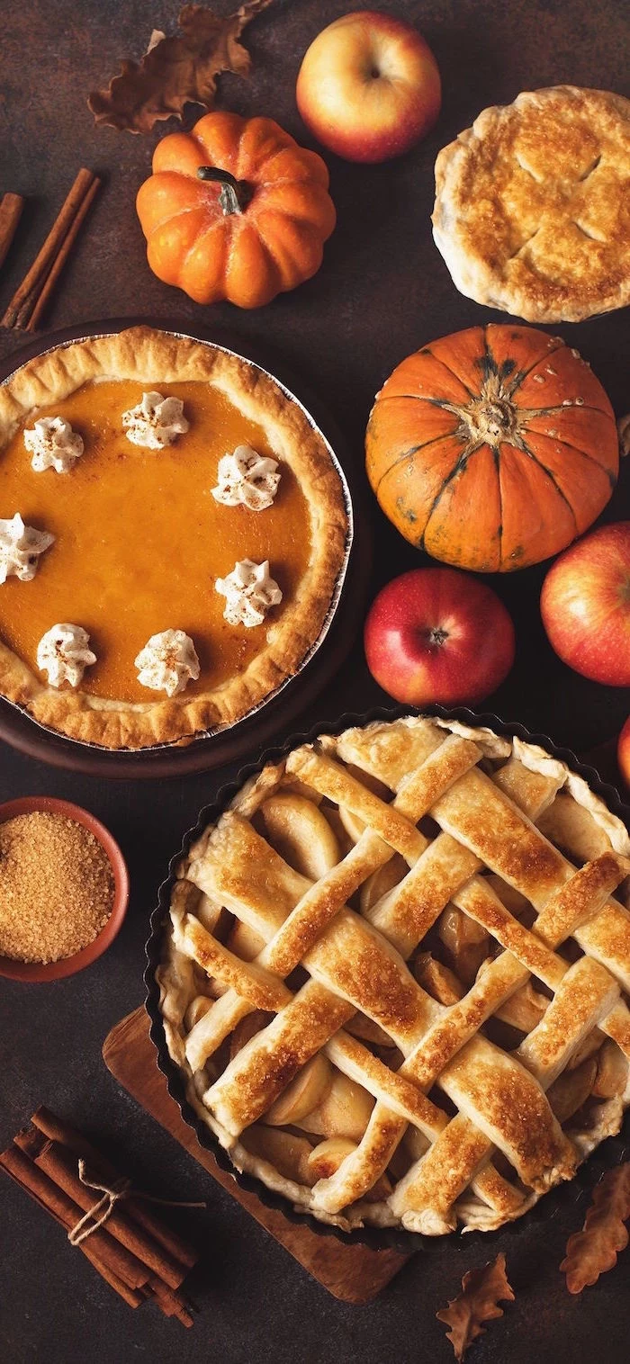 background thanksgiving wallpaper arranged table with pumpkins apple pie pumpkin pie apples cinnamon sticks on brown surface