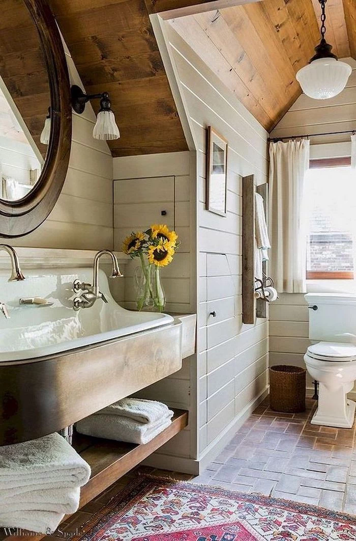 bathroom decor signs vanity with open shelving tiled floor with small rug shiplap on the walls wooden ceiling