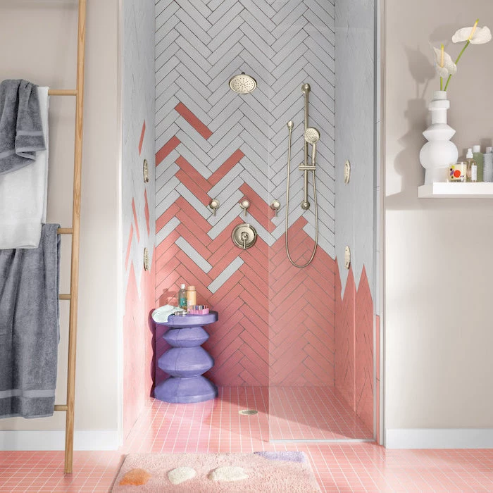 bathroom tile ideas for small bathrooms white and pink chevron tiles under the shower with gols shower heads pink square tiles on the floor