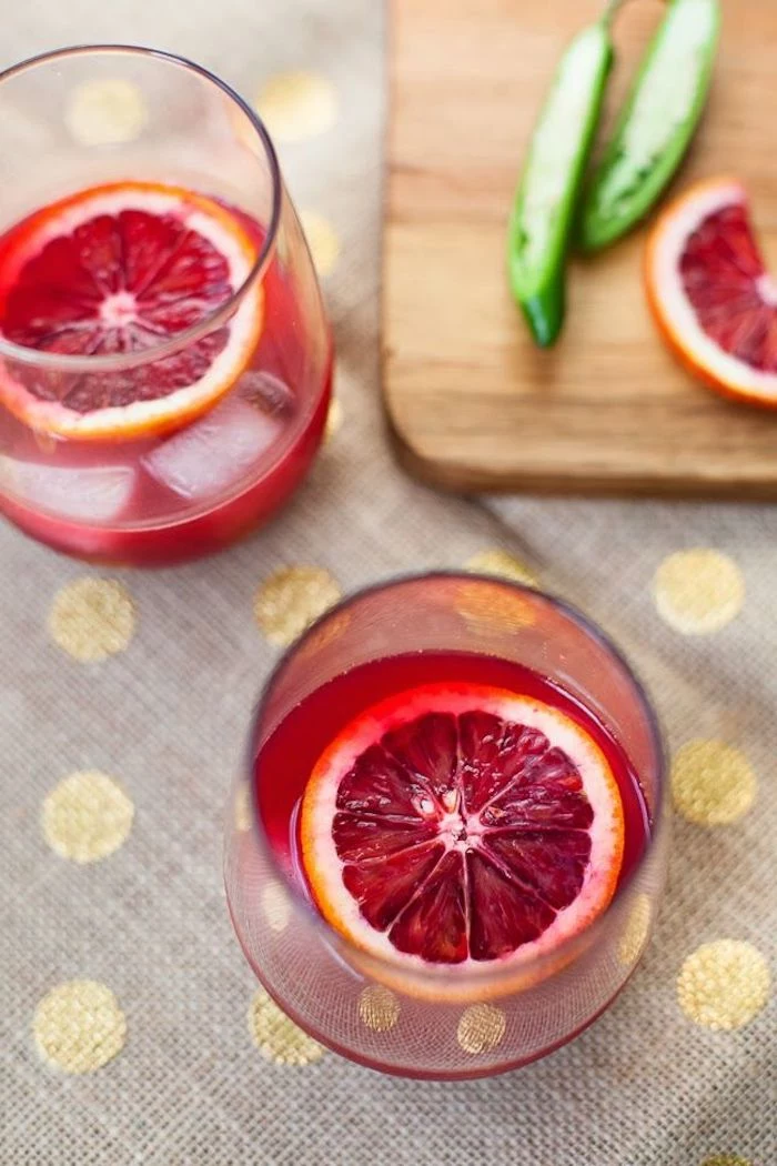 best cleanse for weight loss two glasses filled with red juice best cleanse for weight loss ice and orange slices inside the glasses