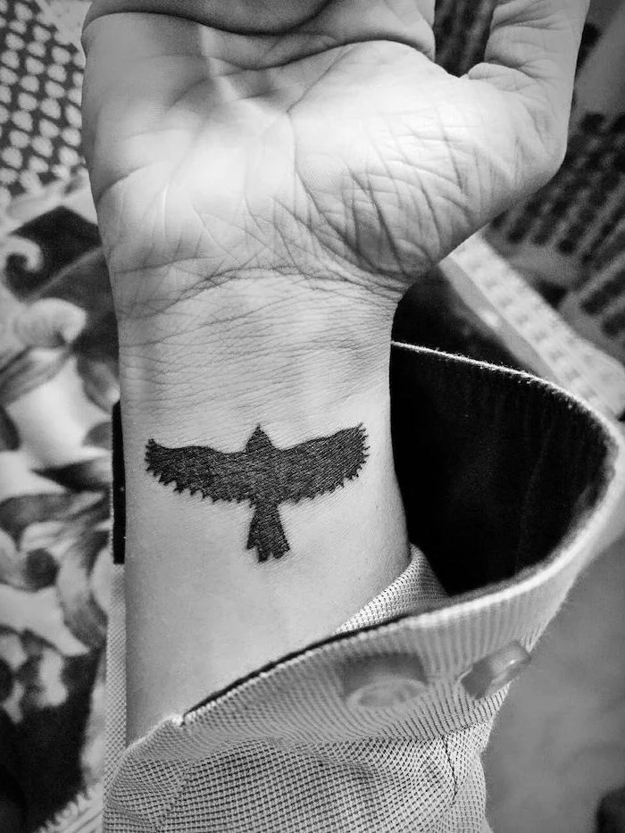 bird with spread wings wrist tattoo shoulder tattoos for men black and white photo