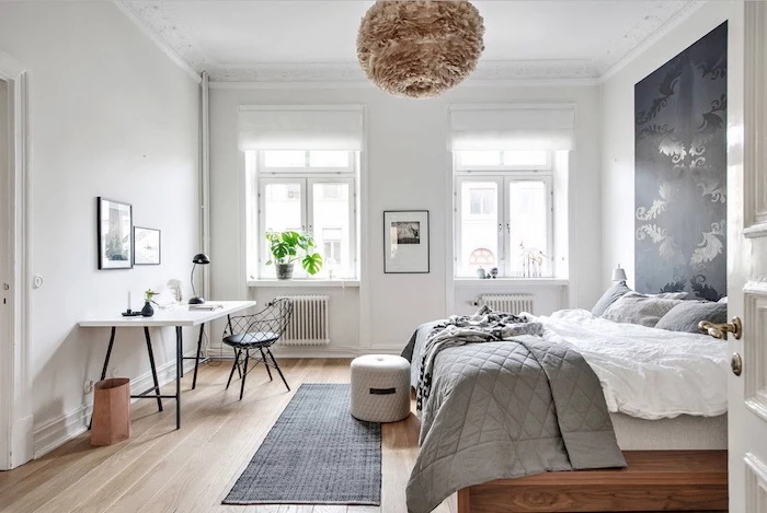 black accent on white wall above the bed scandinavian minimalism small black rug on wooden floor white desk table