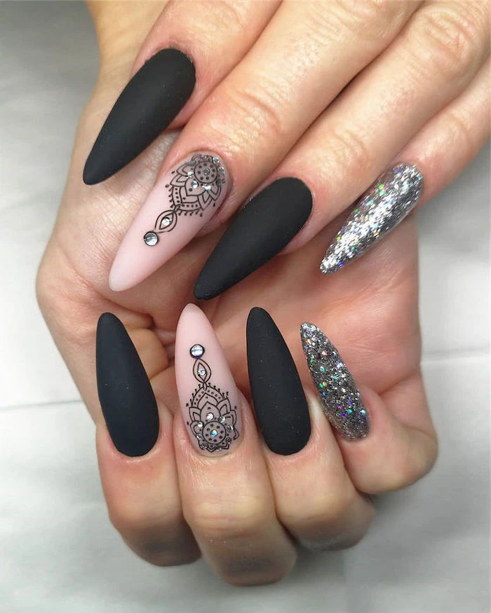 black and nude matte nail polish silver glitter on pinky fingers mandala decorations on middle fingers cute acrylic nails