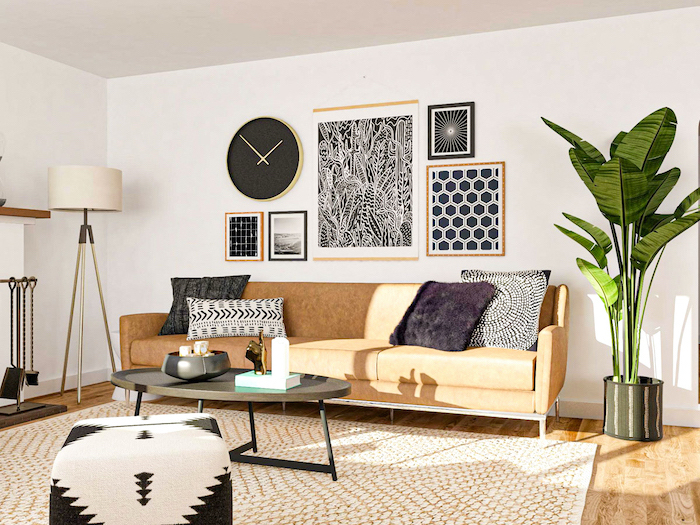 black and white framed art on white wall above brown leather sofa black coffee table modern contemporary living room