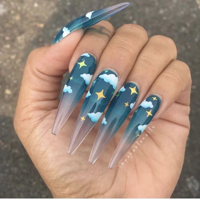 blue sky with white clouds and gold stars on super long stiletto nails acrylic nail ideas