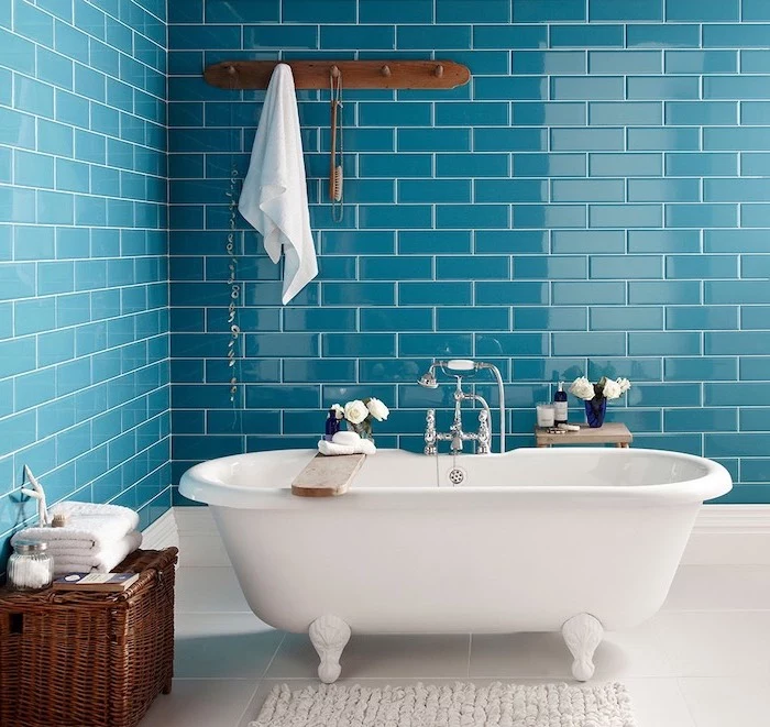 blue subway tiles on the walls behind vintage bathtub best flooring for bathroom white tiles on the floor