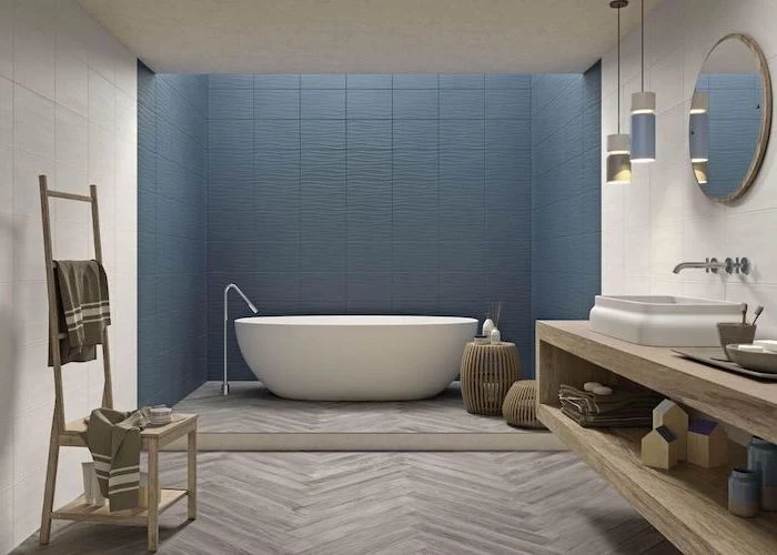 blue tiles on the wall behind the bathtub white tiles on the rest of the walls best flooring for bathroom wooden tiles on the floor