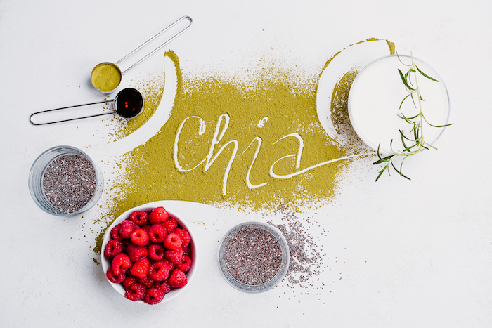 chia written with matcha powder easy vegan appetizers bowl with ingredients around it placed on white surface