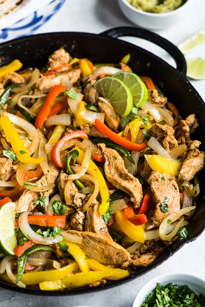 chicken fajitas with peppers onion mexican food recipes garnished with lime slices fresh chopped parsley