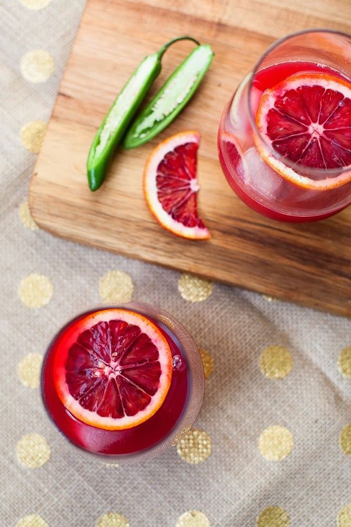 chilli pepper and orange slices best cleanse for weight loss two glasses filled with red juice ice and orange slices