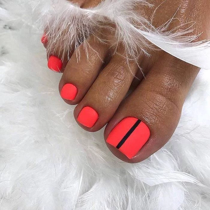 cute acrylic nails pedicure in neon pink matte nail polish one black line across the toe nail