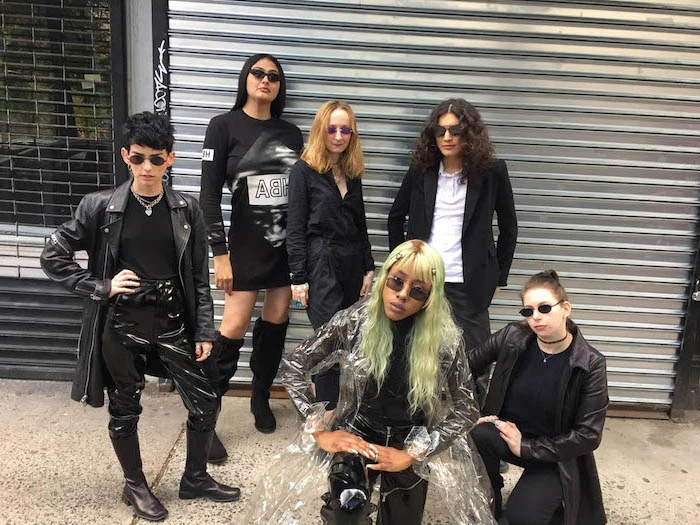 cute group halloween costumes six women dressed in all black as characters from the matrix wearing sunglasses