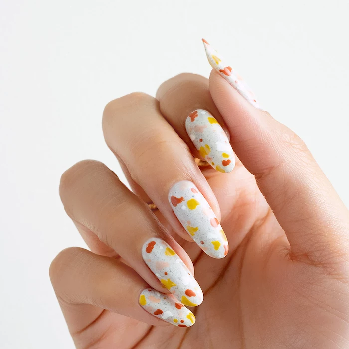 fall leaves in orange and yellow on white nail polish simple nail designs long almond nails