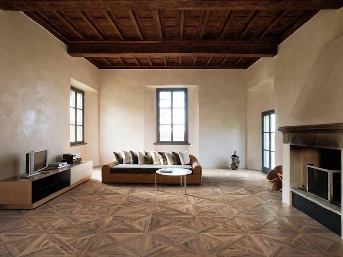 faux wood tiles on the floor exposed wood beams on the ceiling floor tiles minimalistic room design with white walls fireplace