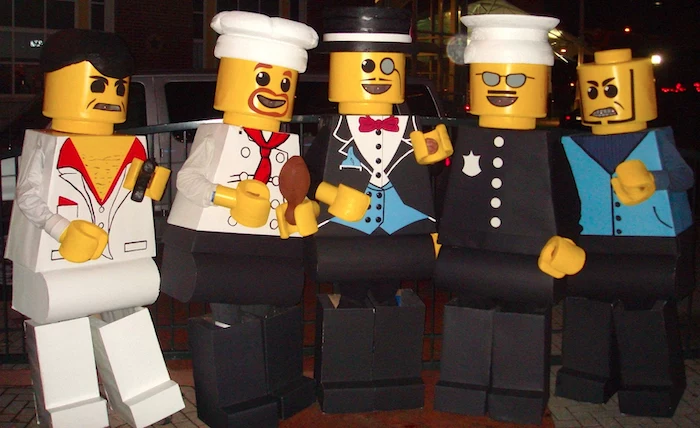 five people dressed as lego figurines girl group halloween costumes photographed together