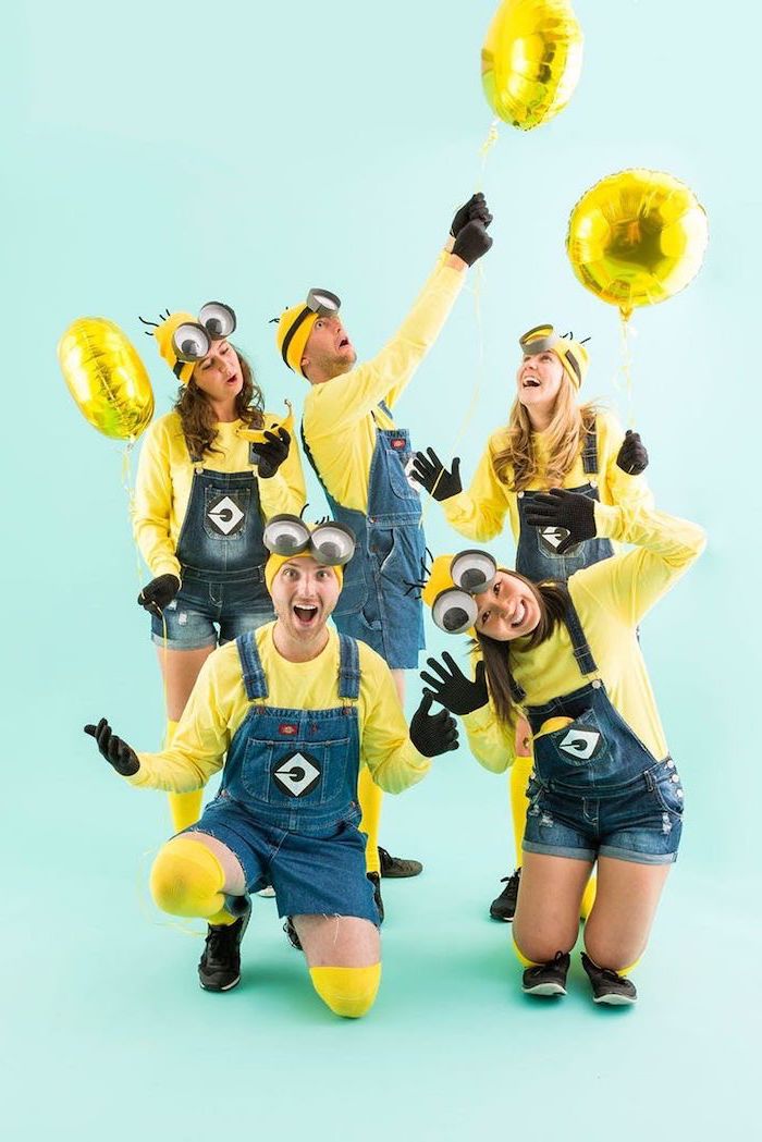 five people dressed as minions cute group halloween costumes denim overalls yellow blouses beanies