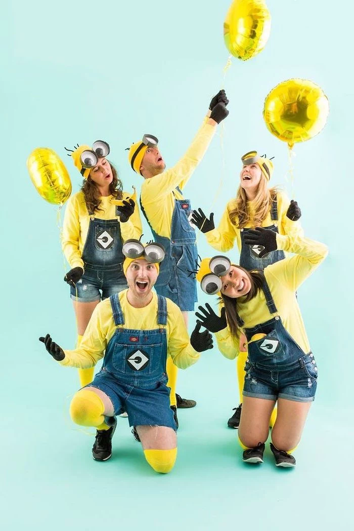 five people dressed as minions cute group halloween costumes denim overalls yellow blouses beanies