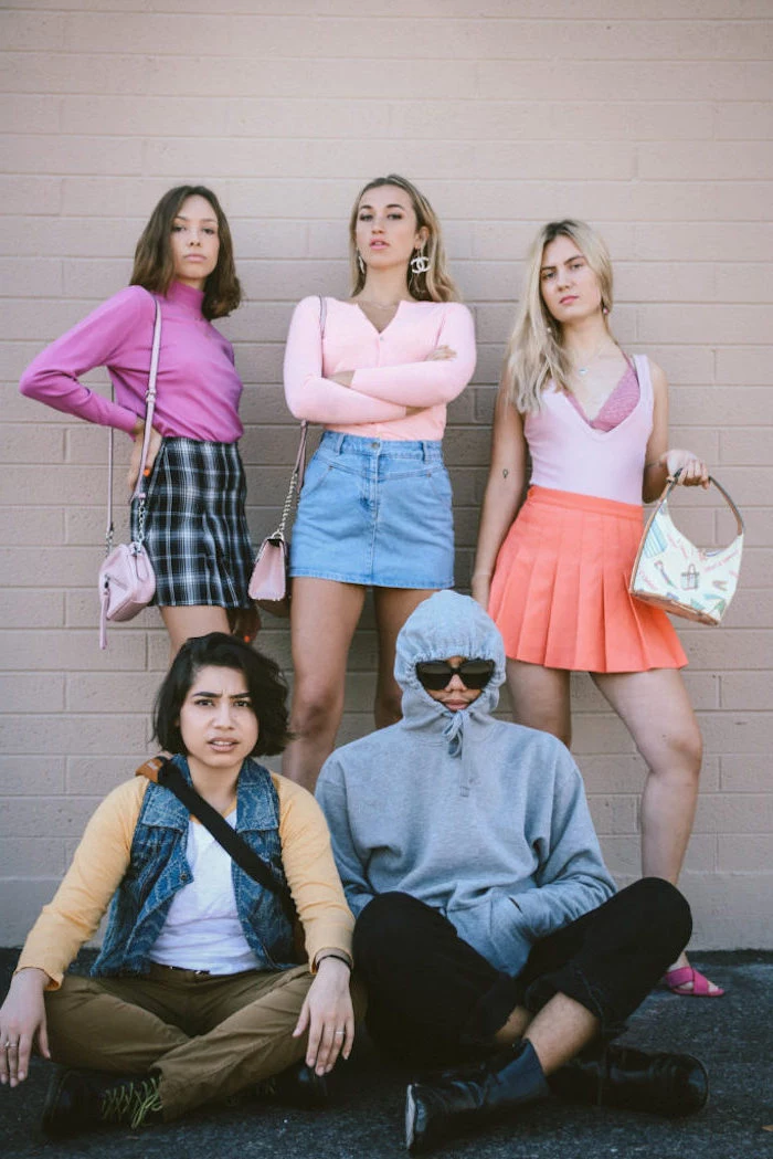 five people dressed as the characters from mean girls group halloween costumes photographed together in front of brick wall