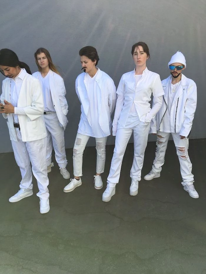 five women dressed as the backstreet boys group halloween costumes wearing white jeans shirts and jackets
