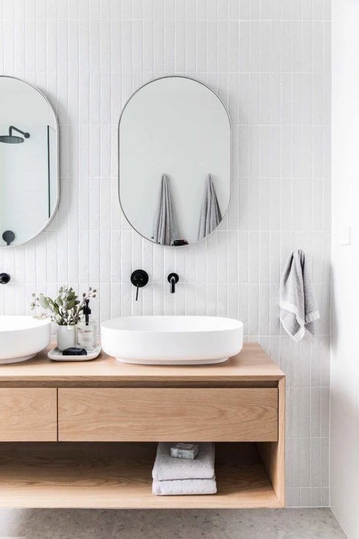 floating wooden vanity in bathroom scandinavian home decor two mirrors hanging on wall covered with white subway tiles