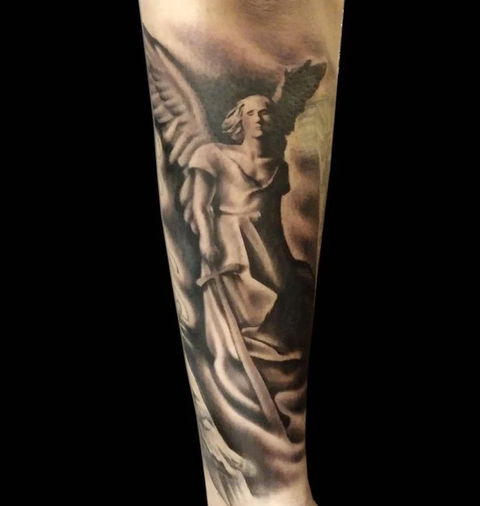 forearm tattoo of an angel holding a sword symbols with deep meanings black background