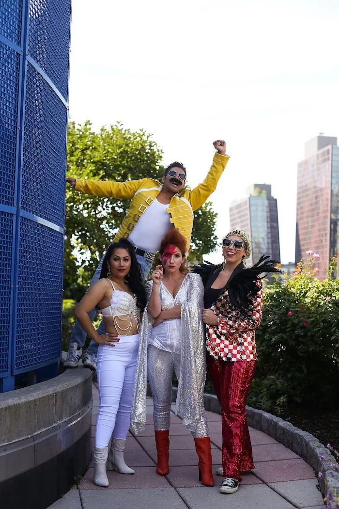 four people dressed as rock musicians legends from the nineties group halloween costumes for work