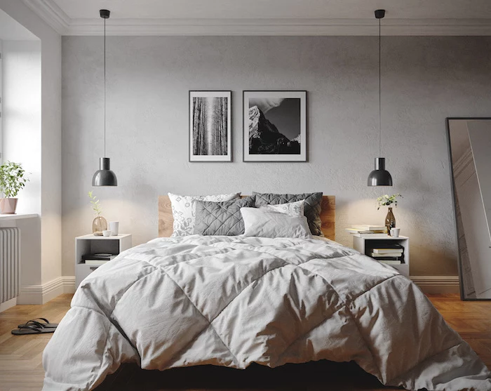 framed black and white photos above the bed scandinavian furniture wooden floor mirror leaning on the wall