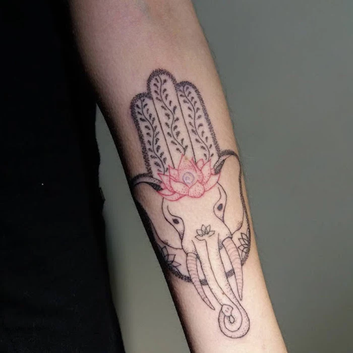 ganesha and hamsa hand with lotus flower combined tattoos that represent growth forearm tattoo