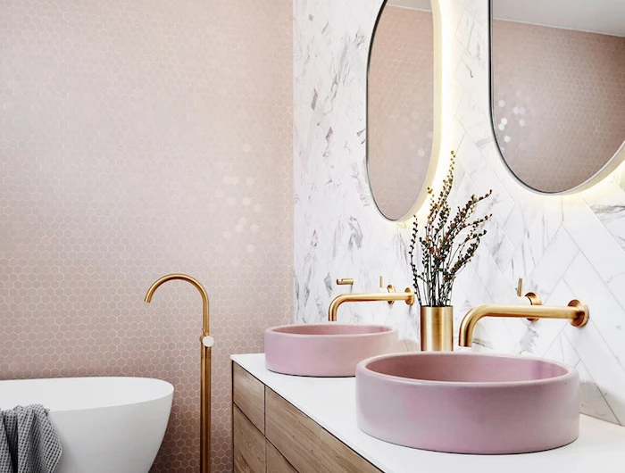 gold brass faucets pink sinks on wooden floating vanity best flooring for bathroom marble subway tiles behind sink pink mosaic tiles behind bathtub