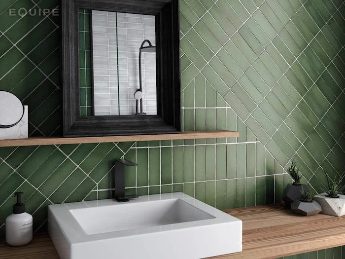 green tiles arranged in different directions on the wall behin the sink with wooden vanity how to tile a bathroom floor