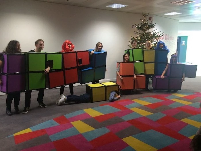 group halloween costumes for work ten people dressed as tetris pieces in different colors photographed in office lobby
