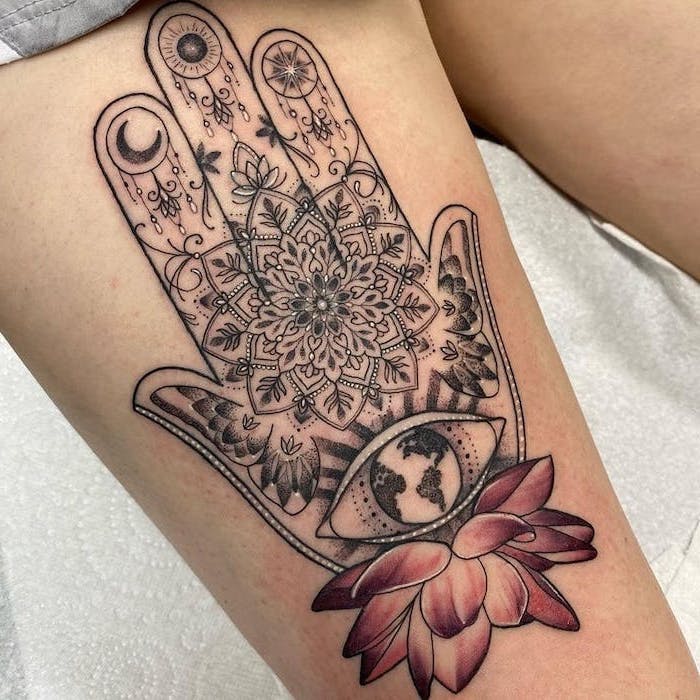 hamsa hand with pink lotus flower underneath tattoos with deep meaning mandala thigh tattoo