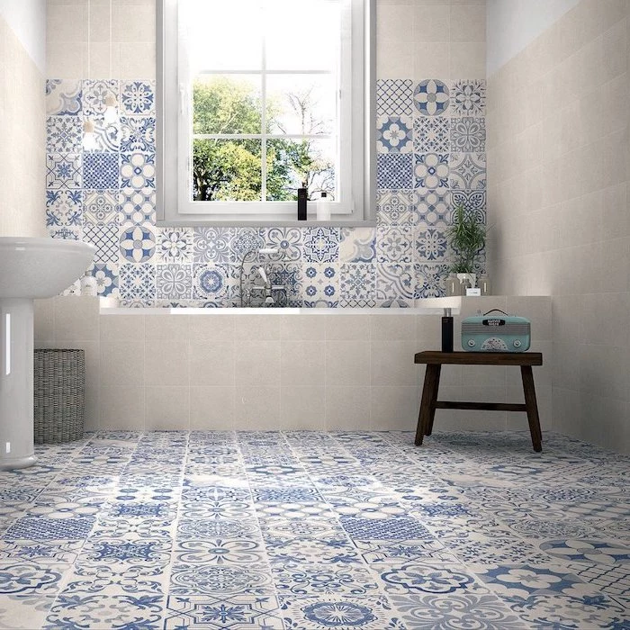 how to tile a bathroom floor blue and white tiles with print on the floor and half of the wall behind bathtub