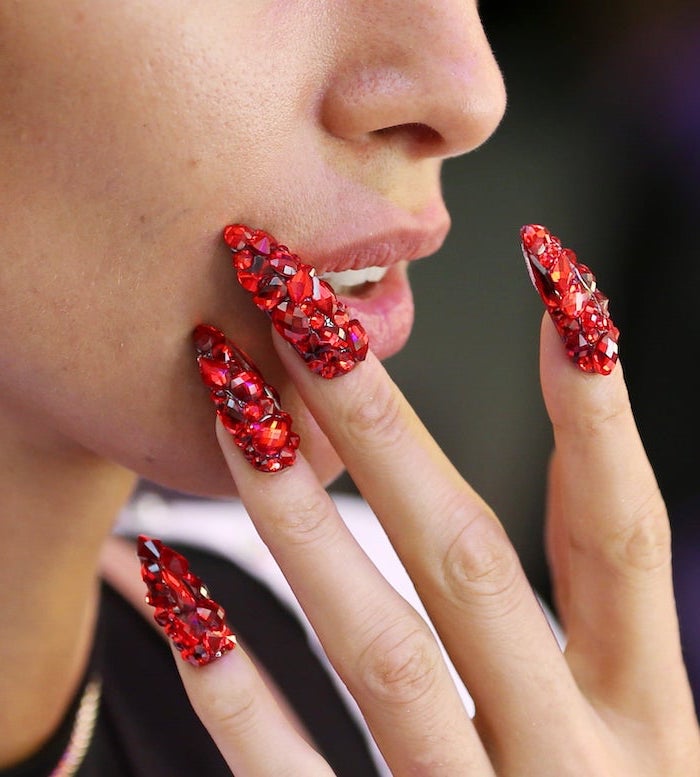 long stiletto nails covered with red rhinestones in different shapes and sizes acrylic nail designs
