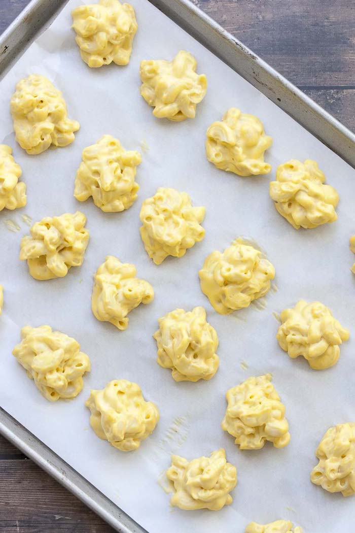 mac and cheese bites arranged on paper lined baking sheet placed on wooden surface vegan party snacks