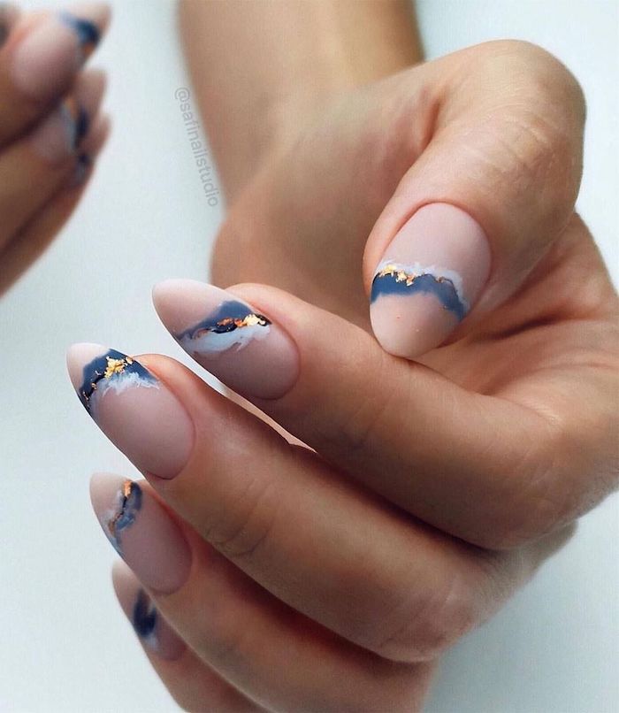 matte nude nail polish cute nail ideas almond nails blue white marble decorations on each nail with gold leaves