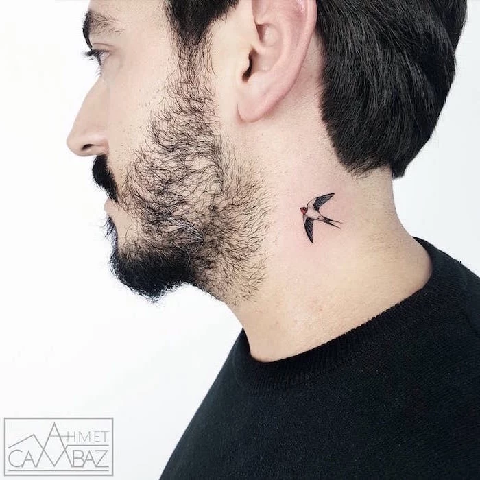 meaningful tattoos for men small neck tattoo of bird with spread wings on man wearing black sweater white background