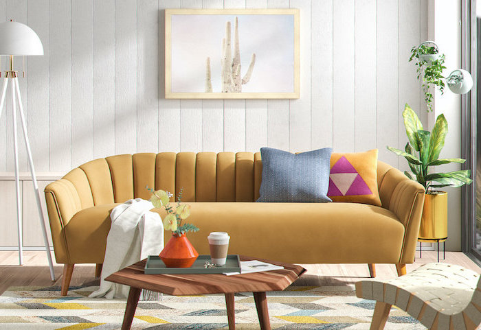 mid century living room beige sofa wooden covvee table white shiplap on the walls colorful carpet on wooden floor