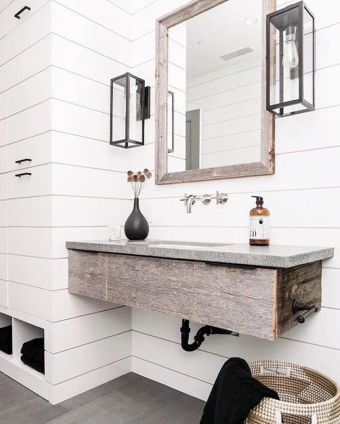 mirror hanging above floating wooden vanity modern farmhouse bathroom walls covered with white shiplap
