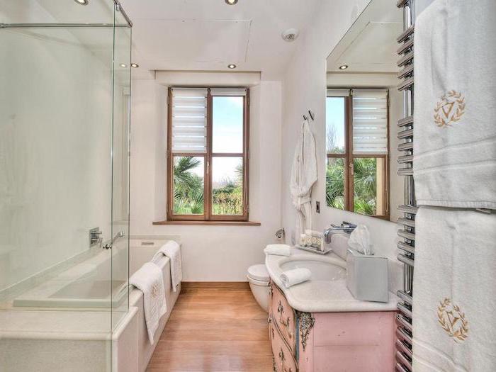 pink vintage vanity with large mirror above it farmhouse bathroom shelves wooden floor white walls