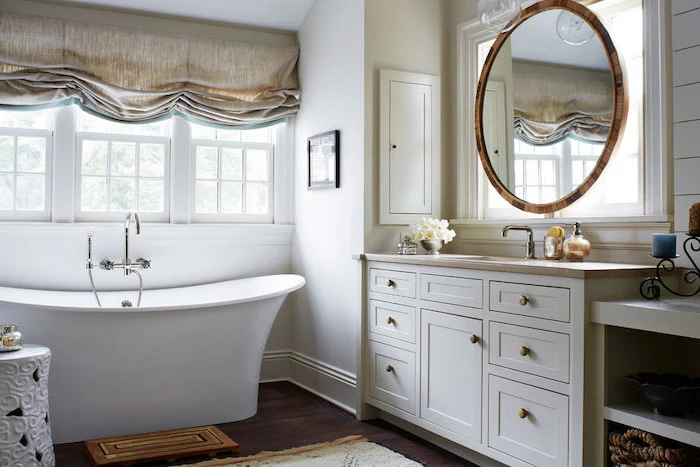 round mirror above white vanity with sink country bahtoom ideas white walls wooden floor with rugs white bath