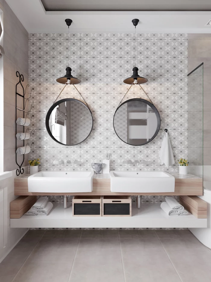 scandinavian home decor bathroom with wooden floating vanity two round mirrors on wall with patterned tiles