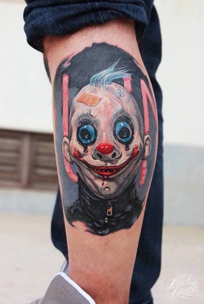 scary tattoo on the side of the leg sleeve tattoo ideas for men man wearing mask of a clown on black background