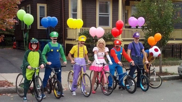 seven people dressed as characters from the super mario franchise funny diy halloween costumes mounted on bikes with balloons