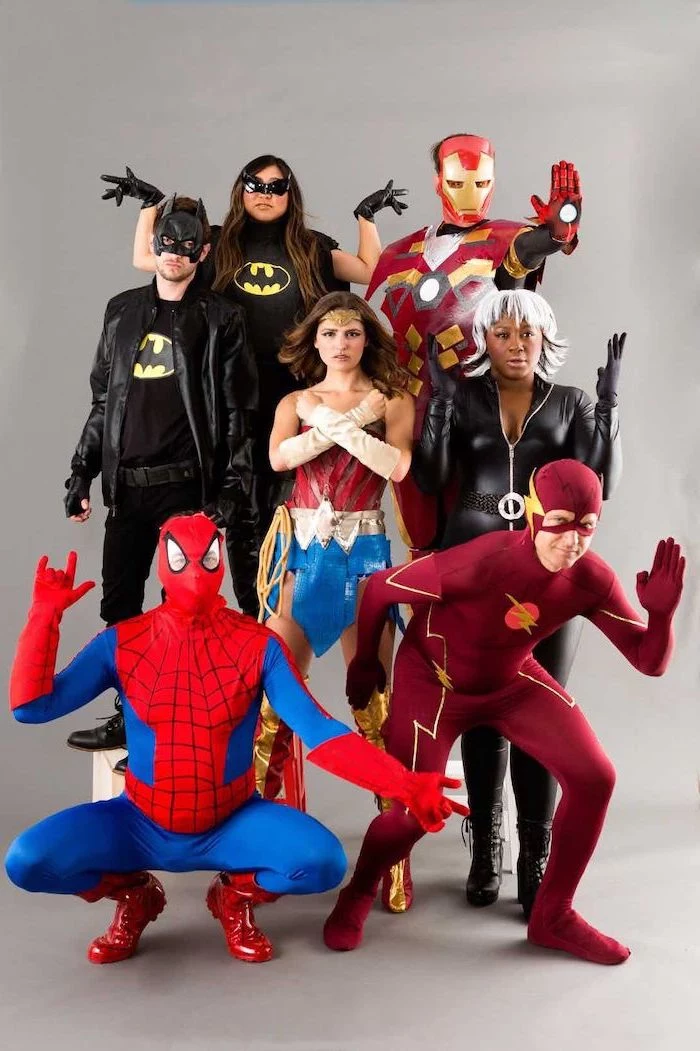 seven people dressed as superheroes from marvel dc comics trio halloween costumes batman batwoman iron man flash wonder woman storm spider man