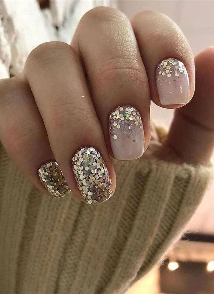 short squoval nails almond shaped nails nude nail polish gold glitter on the ring and pinky fingers
