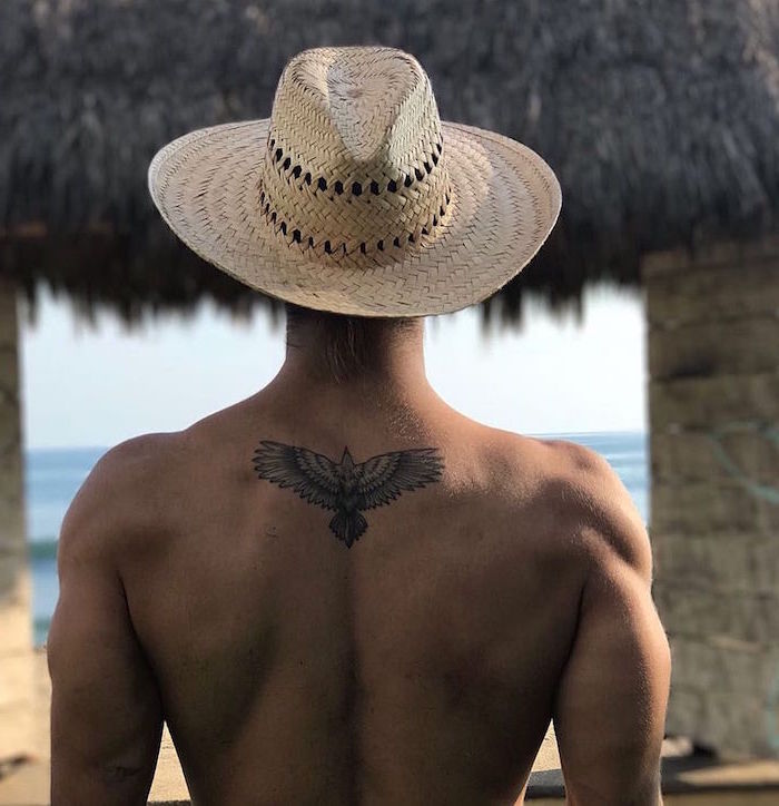 shoulder tattoos for men man wearing straw hat eagle with spread wings tattoo on his back