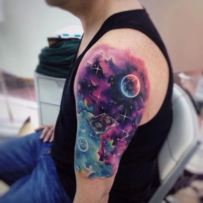 shoulder watercolor tattoo of galaxy sky in purple pink blue cassette tape floating around meaningful tattoos for men